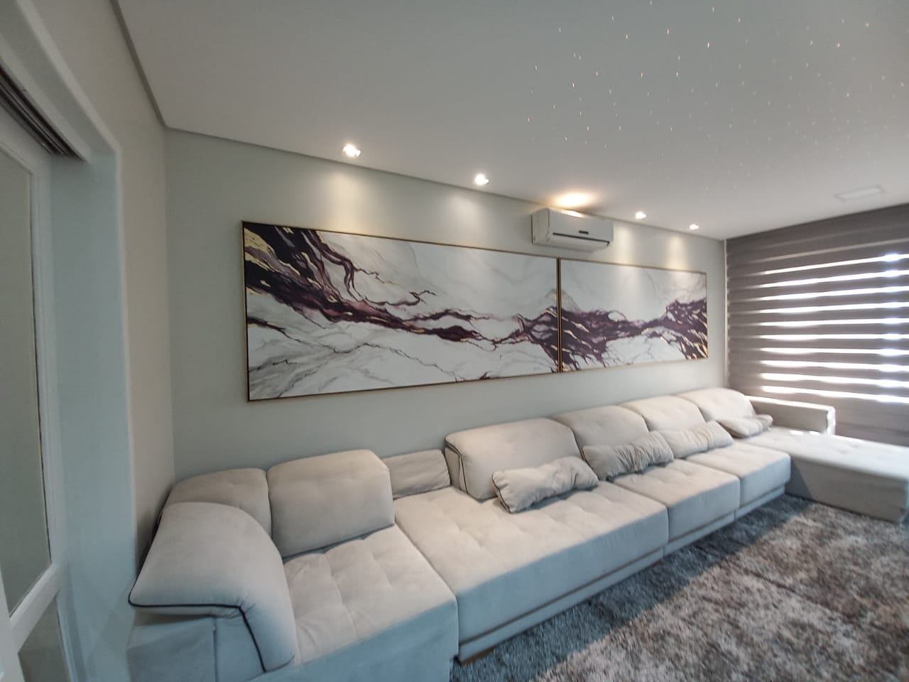 Marbled diptych in purple and gold installed in a living room