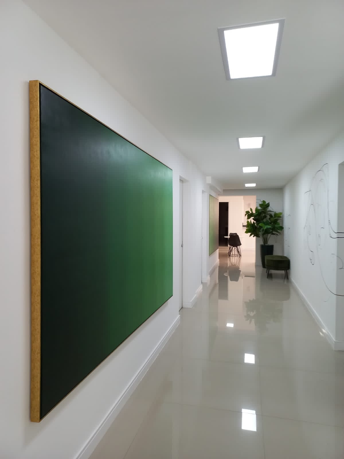 Green gradient painting installed in an entrance hall