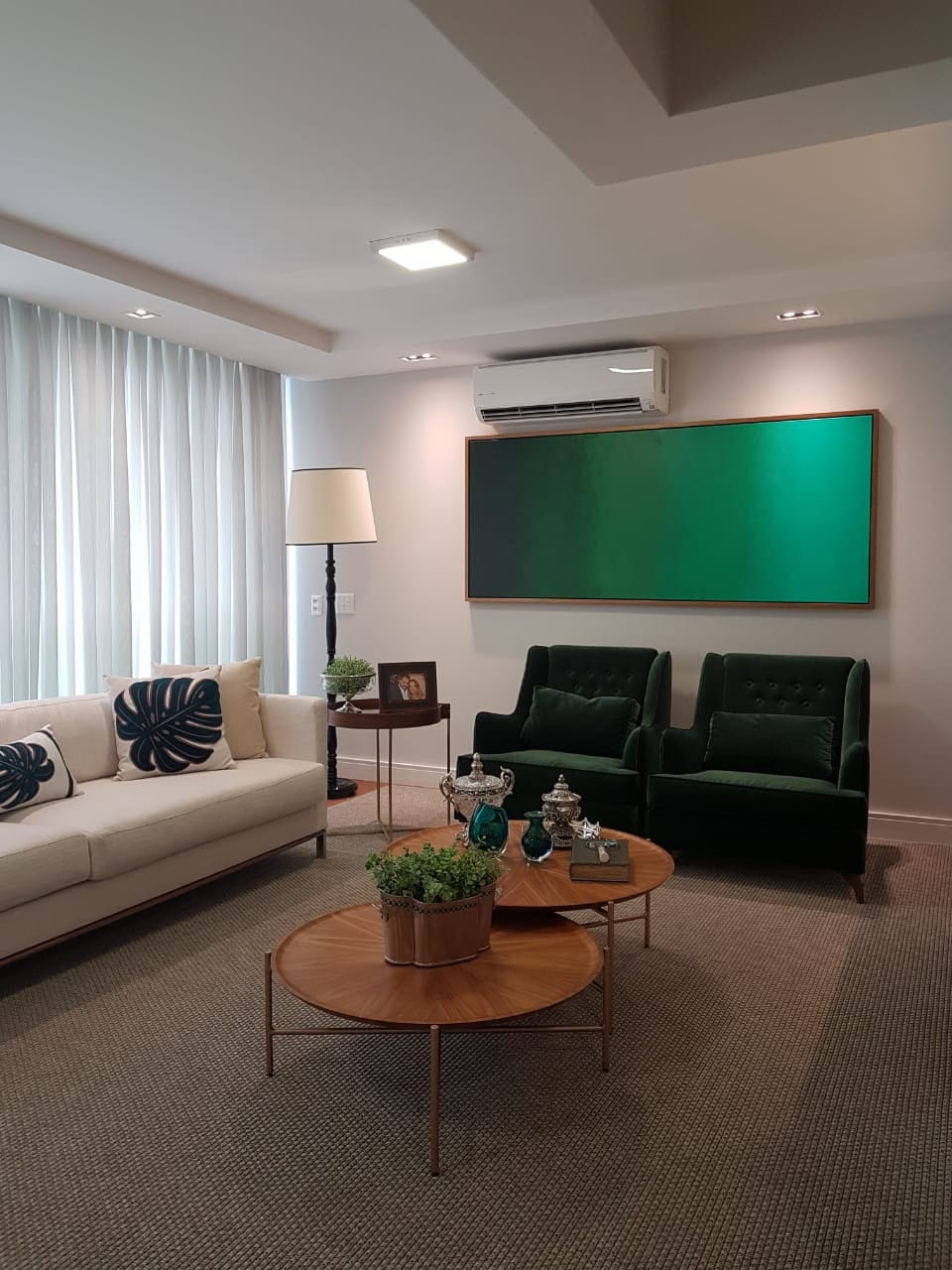 Green gradient painting installed in a living room